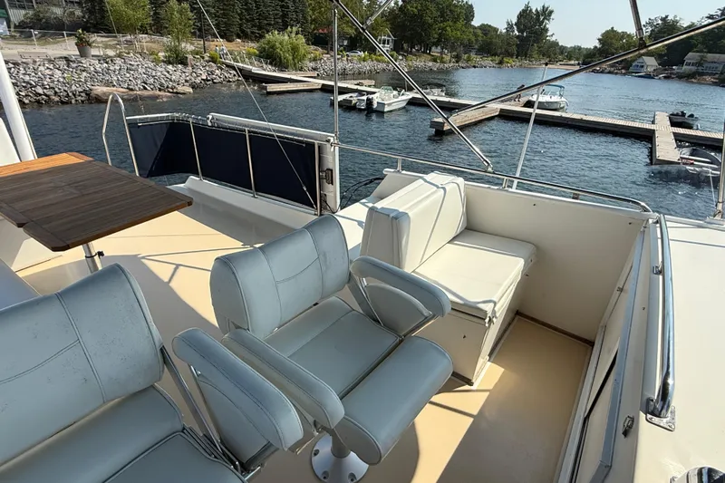  Yacht Photos Pics Flybridge of 1990 Grand Banks 42 Classic yacht with seating and table, dockside view.
