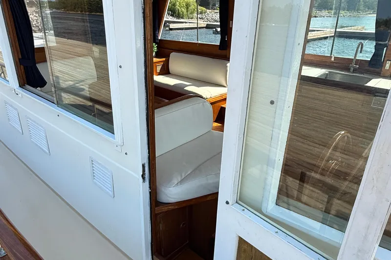  Yacht Photos Pics Interior view of 1990 Grand Banks 42 Classic yacht with seating and window.
