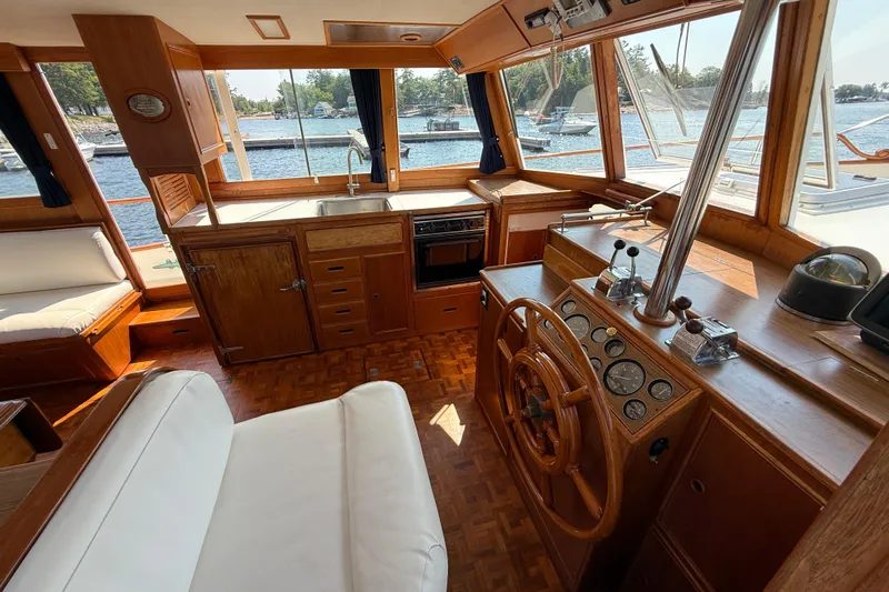  Yacht Photos Pics Interior of 1990 Grand Banks 42 Classic yacht with wooden helm and kitchen area.