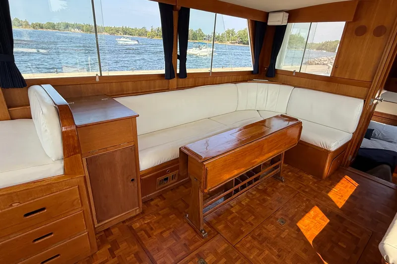  Yacht Photos Pics Interior of 1990 Grand Banks 42 Classic yacht with white seating and wooden table.