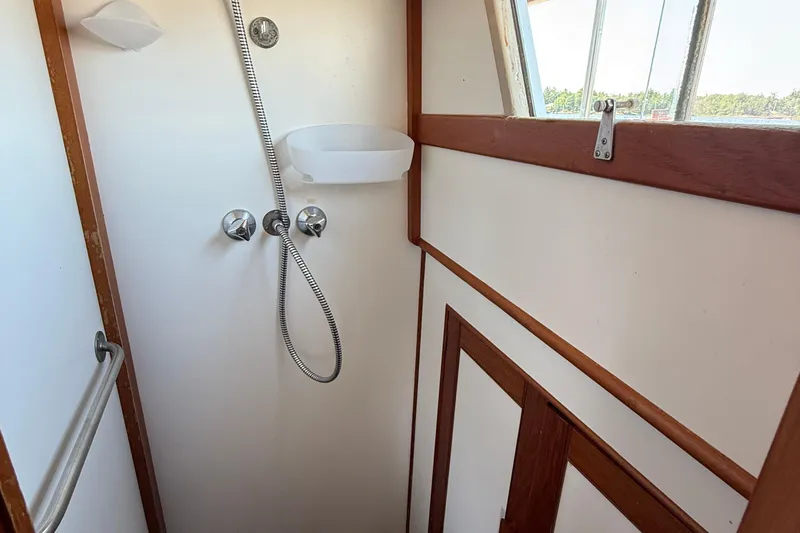  Yacht Photos Pics Shower area in 1990 Grand Banks 42 Classic boat with wooden trim and window.
