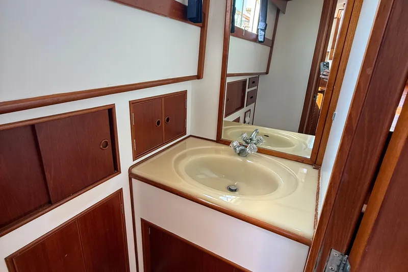  Yacht Photos Pics Bathroom vanity with sink and mirror on 1990 Grand Banks 42 Classic yacht.