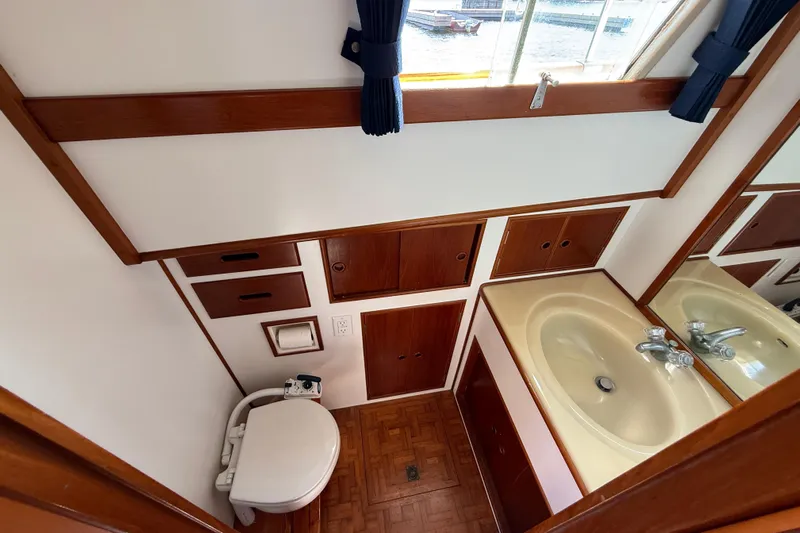  Yacht Photos Pics Bathroom interior of 1990 Grand Banks 42 Classic yacht with sink and toilet.