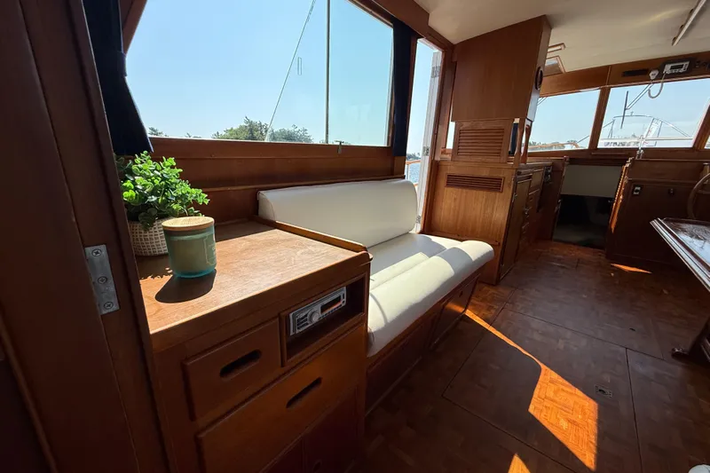  Yacht Photos Pics Interior of 1990 Grand Banks 42 Classic yacht with wooden furnishings and white seating.