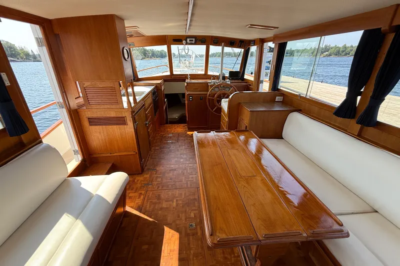  Yacht Photos Pics Interior of 1990 Grand Banks 42 Classic yacht with polished wood and white seating.