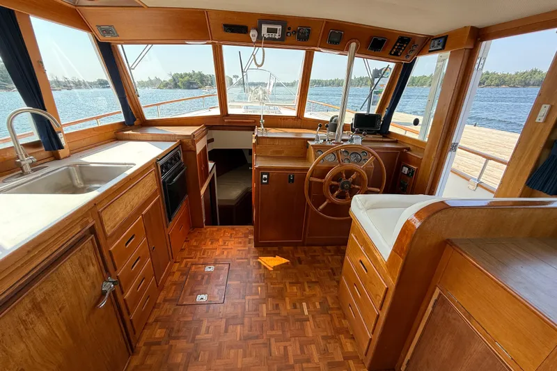  Yacht Photos Pics Interior of 1990 Grand Banks 42 Classic yacht with wooden helm and kitchen area.