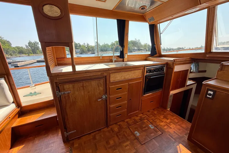  Yacht Photos Pics Interior of 1990 Grand Banks 42 Classic yacht with wooden cabinetry and scenic water view.