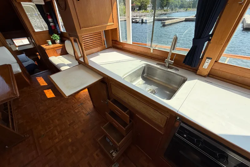  Yacht Photos Pics Interior of 1990 Grand Banks 42 Classic yacht with kitchen sink and seating area.