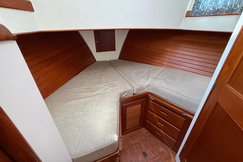  Yacht Photos Pics Cozy cabin interior of 1990 Grand Banks 42 Classic with wooden paneling and twin beds.