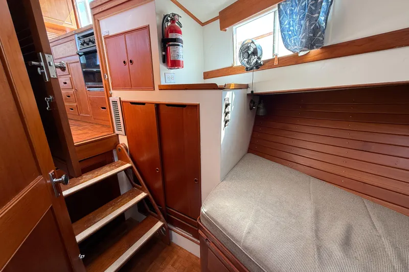  Yacht Photos Pics Interior of 1990 Grand Banks 42 Classic yacht with wooden cabinetry and cozy seating area.