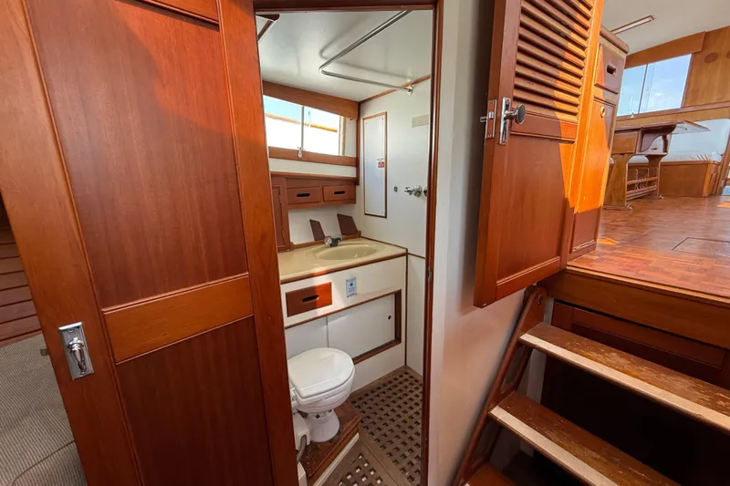  Yacht Photos Pics 1990 Grand Banks 42 Classic yacht interior with wooden cabinetry and compact bathroom.