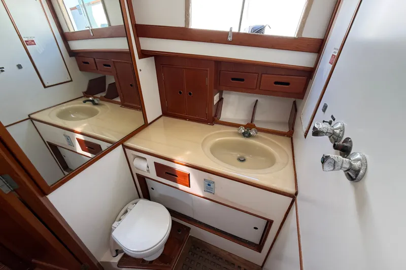  Yacht Photos Pics Bathroom interior of 1990 Grand Banks 42 Classic yacht with sink and toilet.