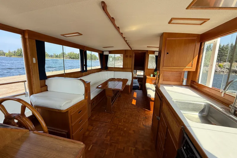  Yacht Photos Pics Interior of a 1990 Grand Banks 42 Classic yacht with wood finishes and scenic water views.