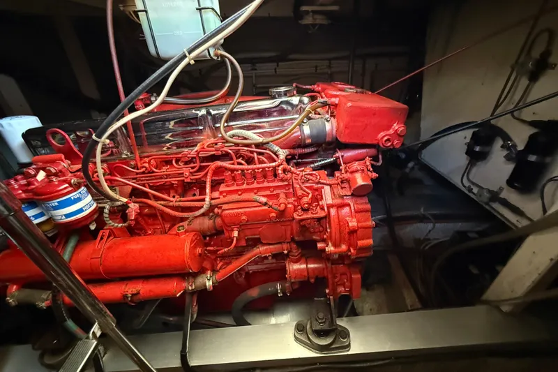  Yacht Photos Pics Engine room of a 1990 Grand Banks 42 Classic yacht, featuring a red-painted engine.