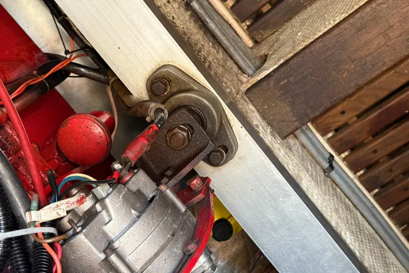  Yacht Photos Pics Engine component of a 1990 Grand Banks 42 Classic boat, featuring red and metallic parts.