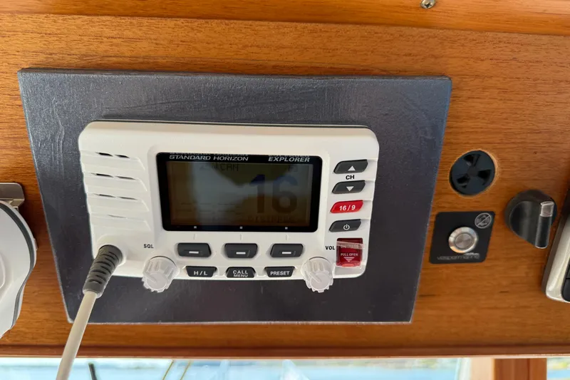  Yacht Photos Pics VHF radio on 1990 Grand Banks 42 Classic boat dashboard, featuring Standard Horizon Explorer model.