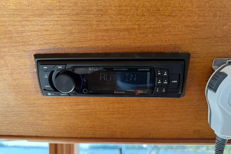  Yacht Photos Pics Audio system on a 1990 Grand Banks 42 Classic boat, displaying "AUX IN".