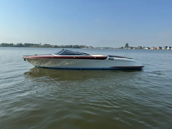 Amore Yacht Photos Pics 2015 Riva Aquariva Super boat on calm water under clear blue sky.