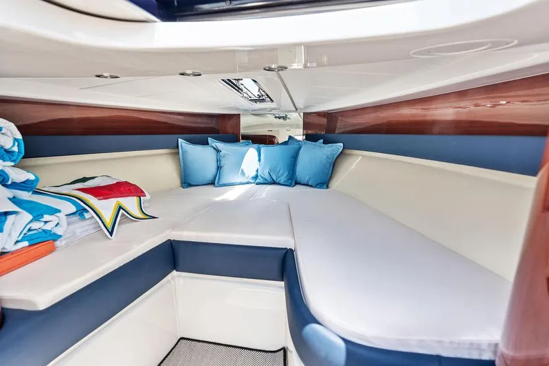 Amore Yacht Photos Pics Interior cabin of 2015 Riva Aquariva Super with blue cushions and white seating.