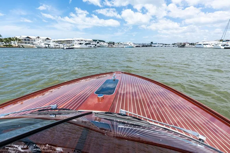 Amore Yacht Photos Pics 2015 Riva Aquariva Super cruising on a sunny day, showcasing elegant wooden deck design.