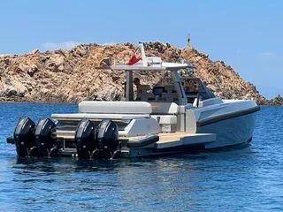  Yacht Photos Pics 2021 Wally Tender 48X boat with four engines, cruising near rocky island.