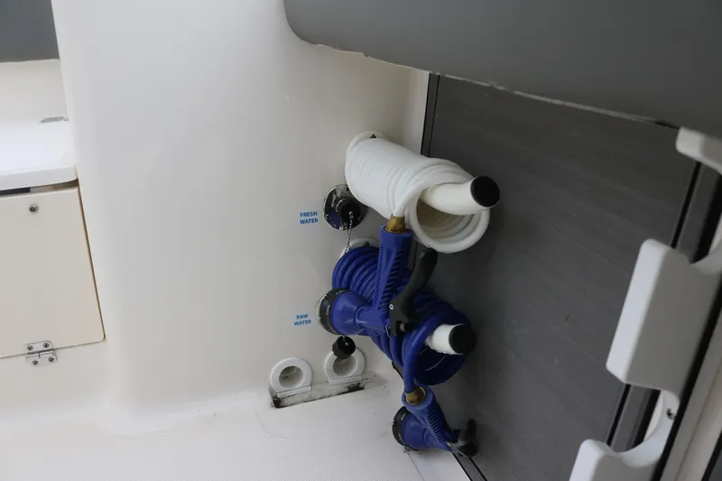  Yacht Photos Pics 2024 Sea Born LX 26 boat interior with water hose storage and fittings.