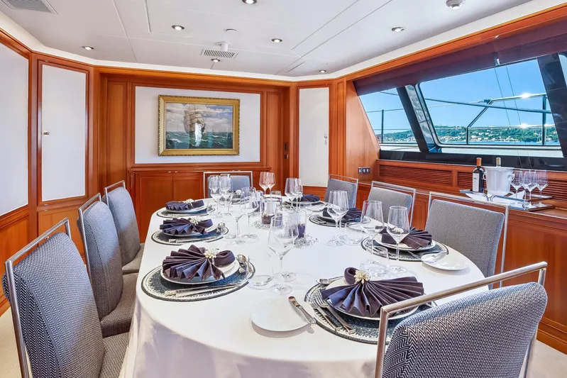 Zenji Yacht Photos Pics Luxurious dining area on 2004 Perini Navi 56m yacht, elegantly set table with ocean view.