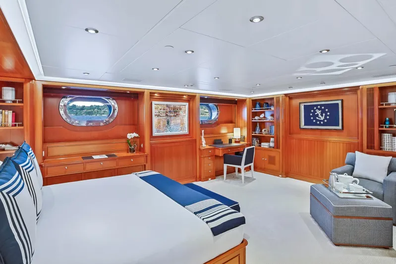 Zenji Yacht Photos Pics Luxurious Perini Navi 56m yacht bedroom, elegant wood paneling, cozy seating, and nautical decor, 2004 model.