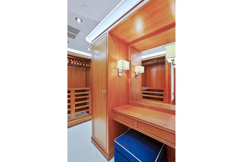 Zenji Yacht Photos Pics Luxurious wooden interior of 2004 Perini Navi 56m yacht, featuring elegant vanity and closet.