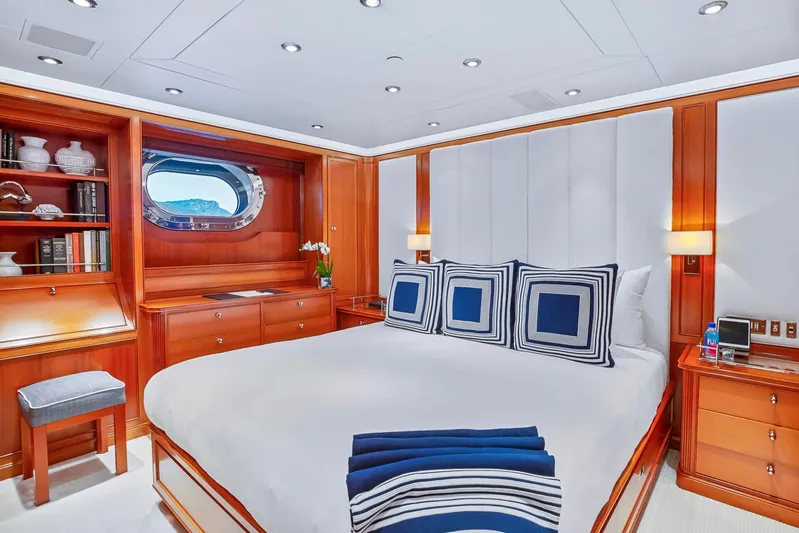 Zenji Yacht Photos Pics Luxurious bedroom interior on 2004 Perini Navi 56m yacht, featuring elegant wood paneling and nautical decor.