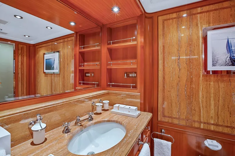 Zenji Yacht Photos Pics Luxurious yacht bathroom with marble sink, wooden cabinetry, and elegant fixtures on a 2004 Perini Navi 56m.