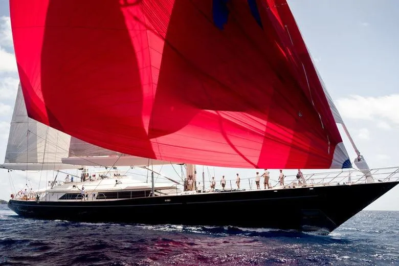 Zenji Yacht Photos Pics Luxurious 2004 Perini Navi 56m yacht with striking red sails on open sea.