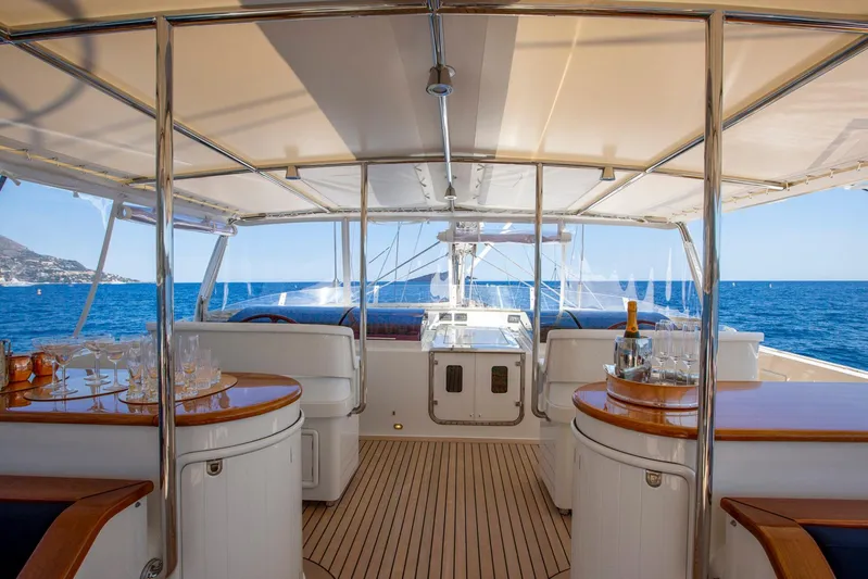Zenji Yacht Photos Pics Luxurious 2004 Perini Navi 56m yacht deck with elegant seating and ocean view.