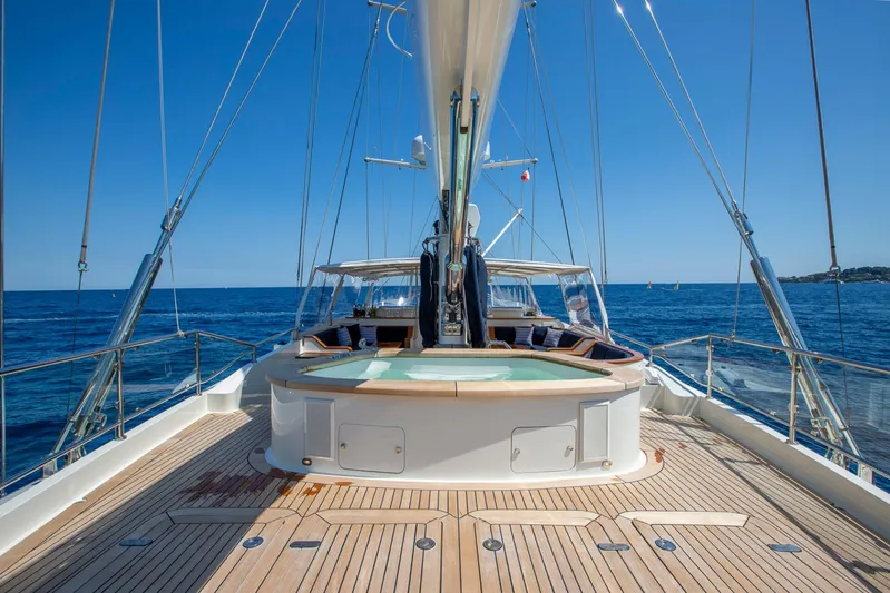 Zenji Yacht Photos Pics Luxurious 2004 Perini Navi 56m yacht deck with jacuzzi, sailing on open sea.