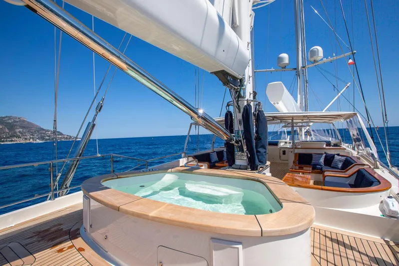 Zenji Yacht Photos Pics Luxurious 2004 Perini Navi 56m yacht with jacuzzi and seating area on deck.