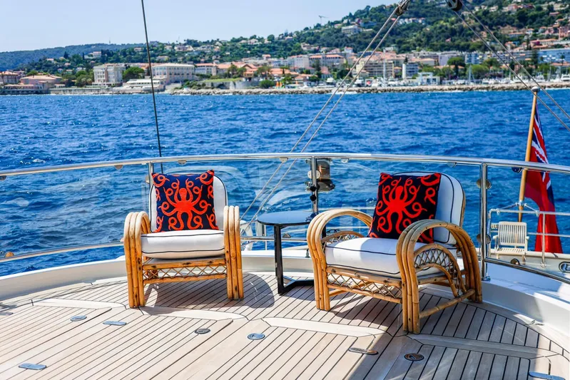 Zenji Yacht Photos Pics Luxurious Perini Navi 56m yacht deck with ocean view, featuring stylish wicker chairs, 2004 model.