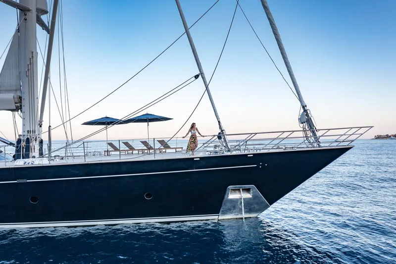 Zenji Yacht Photos Pics Luxurious 2004 Perini Navi 56m yacht with deck chairs and parasols at sea.