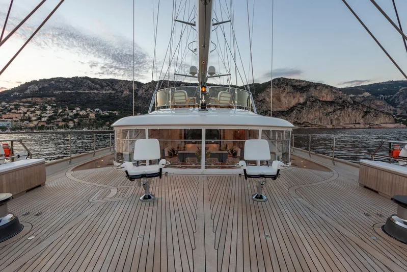 Zenji Yacht Photos Pics Luxurious 2004 Perini Navi 56m yacht deck with scenic coastal backdrop.