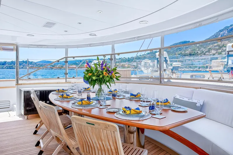 Zenji Yacht Photos Pics Luxurious dining area on 2004 Perini Navi 56m yacht with ocean view and elegant table setting.