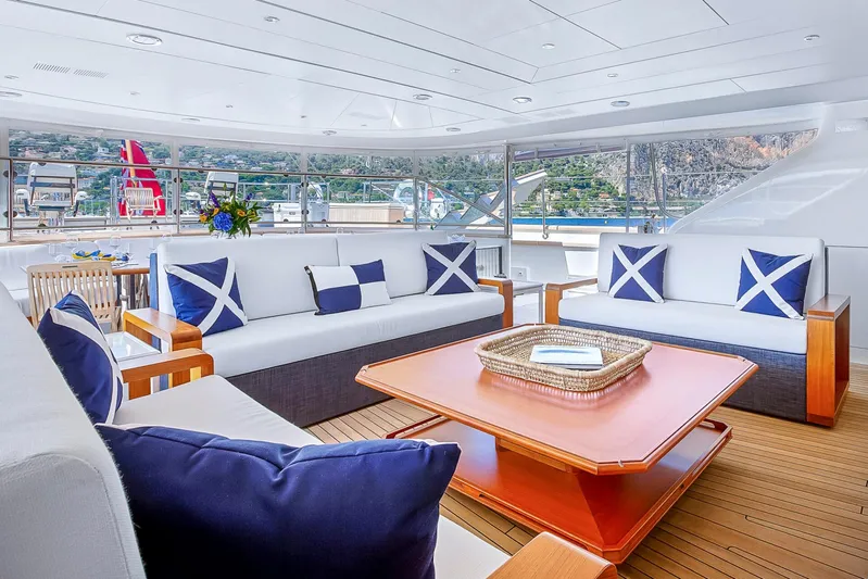 Zenji Yacht Photos Pics Luxurious Perini Navi 56m yacht deck with elegant seating, blue cushions, and scenic views, built in 2004.