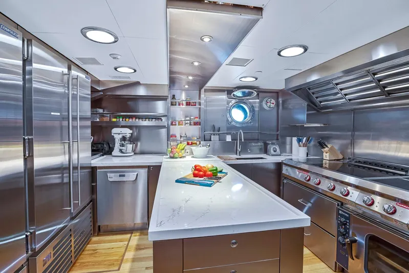 Zenji Yacht Photos Pics Luxurious stainless steel yacht kitchen on 2004 Perini Navi 56m, featuring modern appliances and sleek design.
