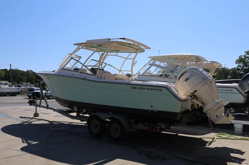  Yacht Photos Pics 2026 Grady-White Canyon 306 boat on trailer, parked outdoors under clear sky.