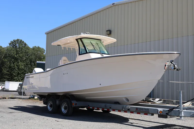  Yacht Photos Pics 2026 Grady-White Canyon 306 boat on trailer, parked outdoors near a building.