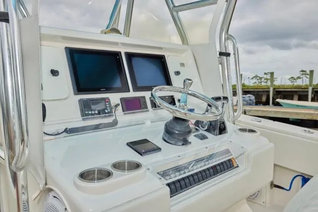  Yacht Photos Pics Control panel of a 2015 Invincible 36 boat with dual screens and steering wheel.