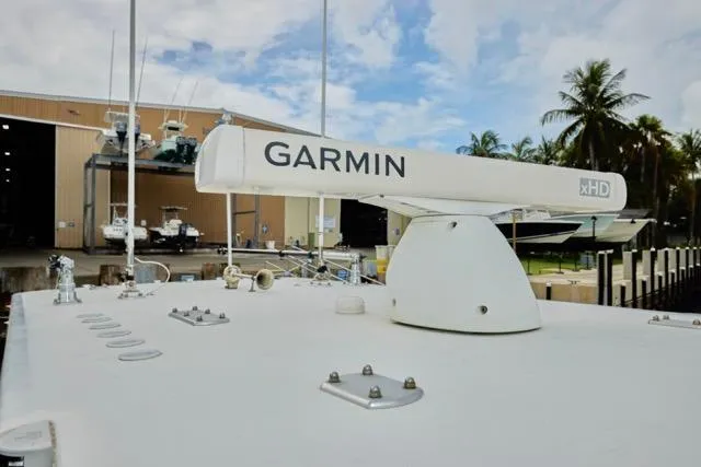  Yacht Photos Pics Garmin radar on 2015 Invincible 36 boat, docked near a warehouse and palm trees.