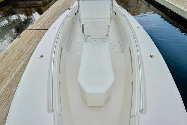  Yacht Photos Pics 2015 Invincible 36 boat deck, spacious seating, docked by calm water.