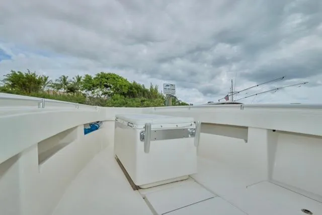  Yacht Photos Pics 2015 Invincible 36 boat deck with storage box under cloudy sky.