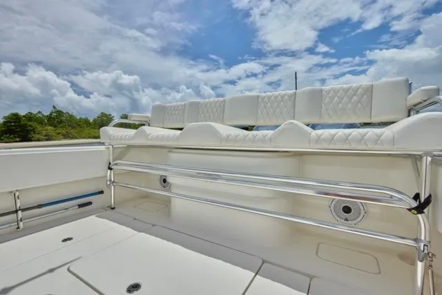  Yacht Photos Pics Luxurious seating on 2015 Invincible 36 boat under a partly cloudy sky.