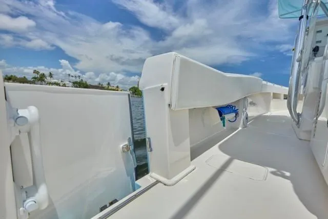  Yacht Photos Pics 2015 Invincible 36 boat deck with open side door, under a clear blue sky.