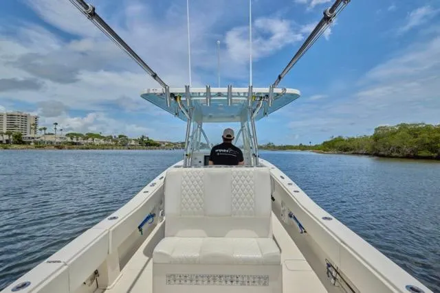  Yacht Photos Pics Invincible 36 boat cruising on a calm river, 2015 model, clear sky.